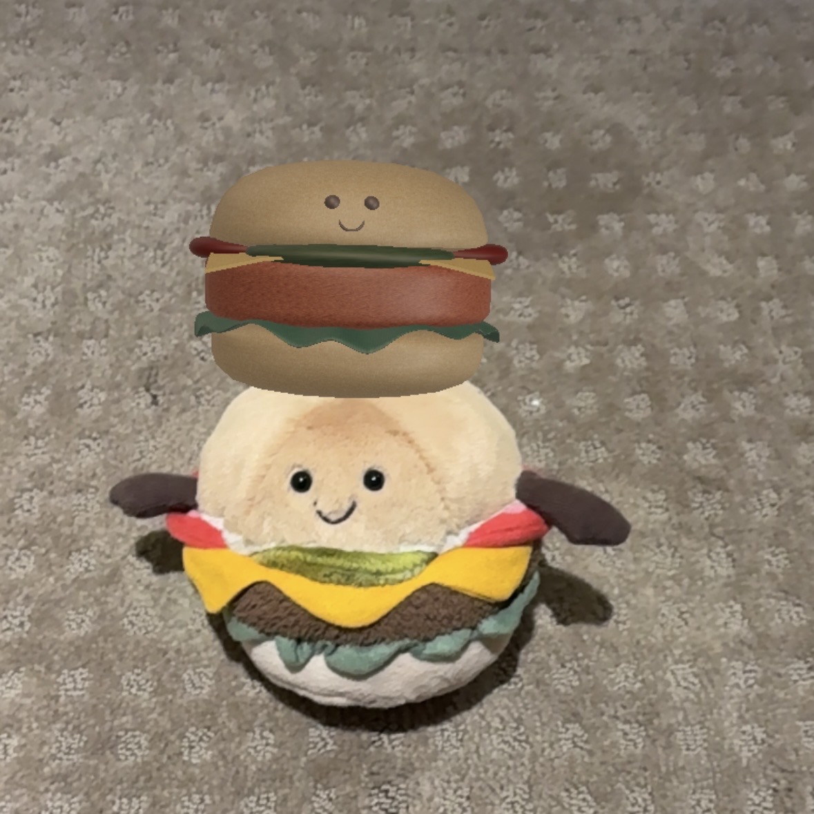 Little digital burger on the top of the fluffy toy burger