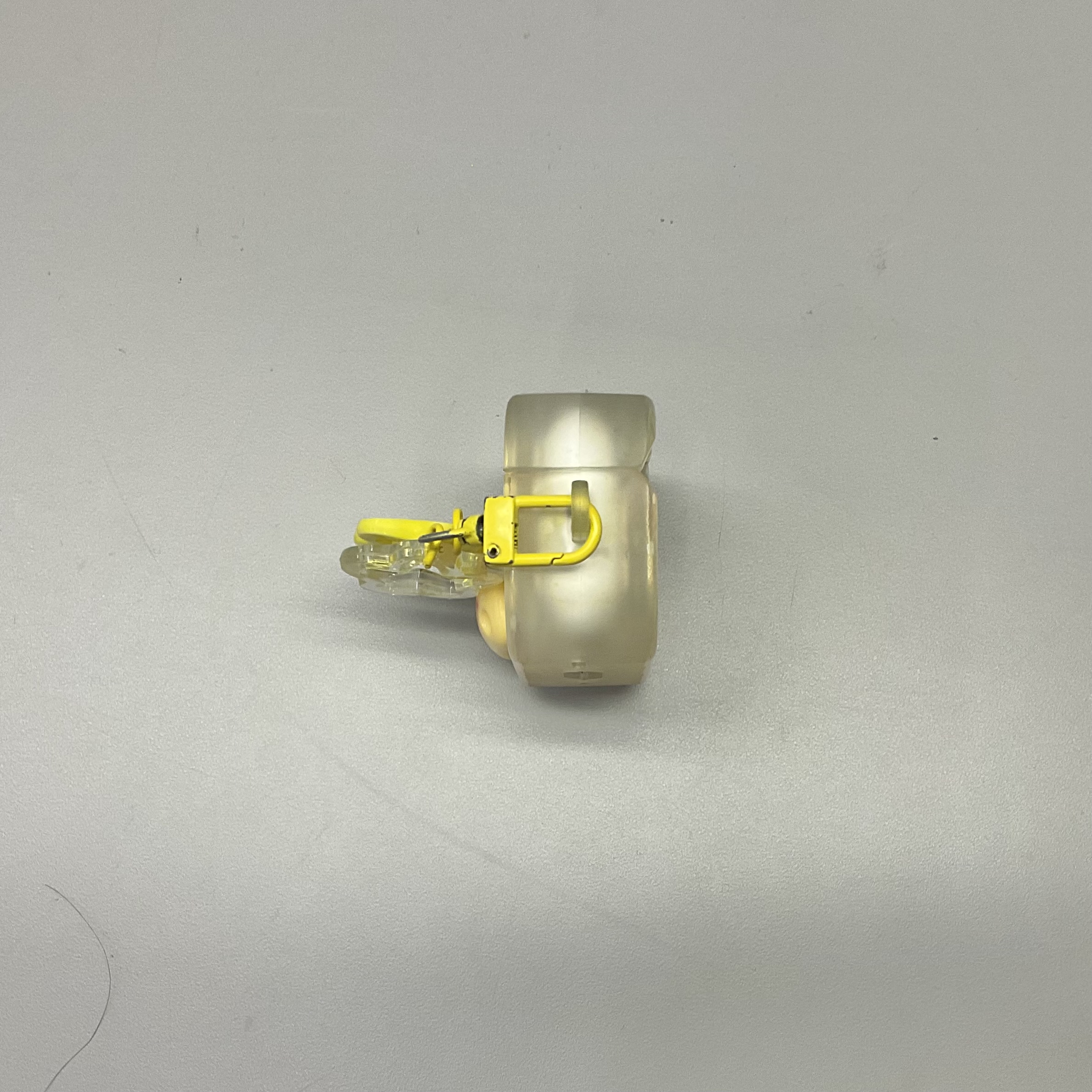 side view of a yellow earbuds case