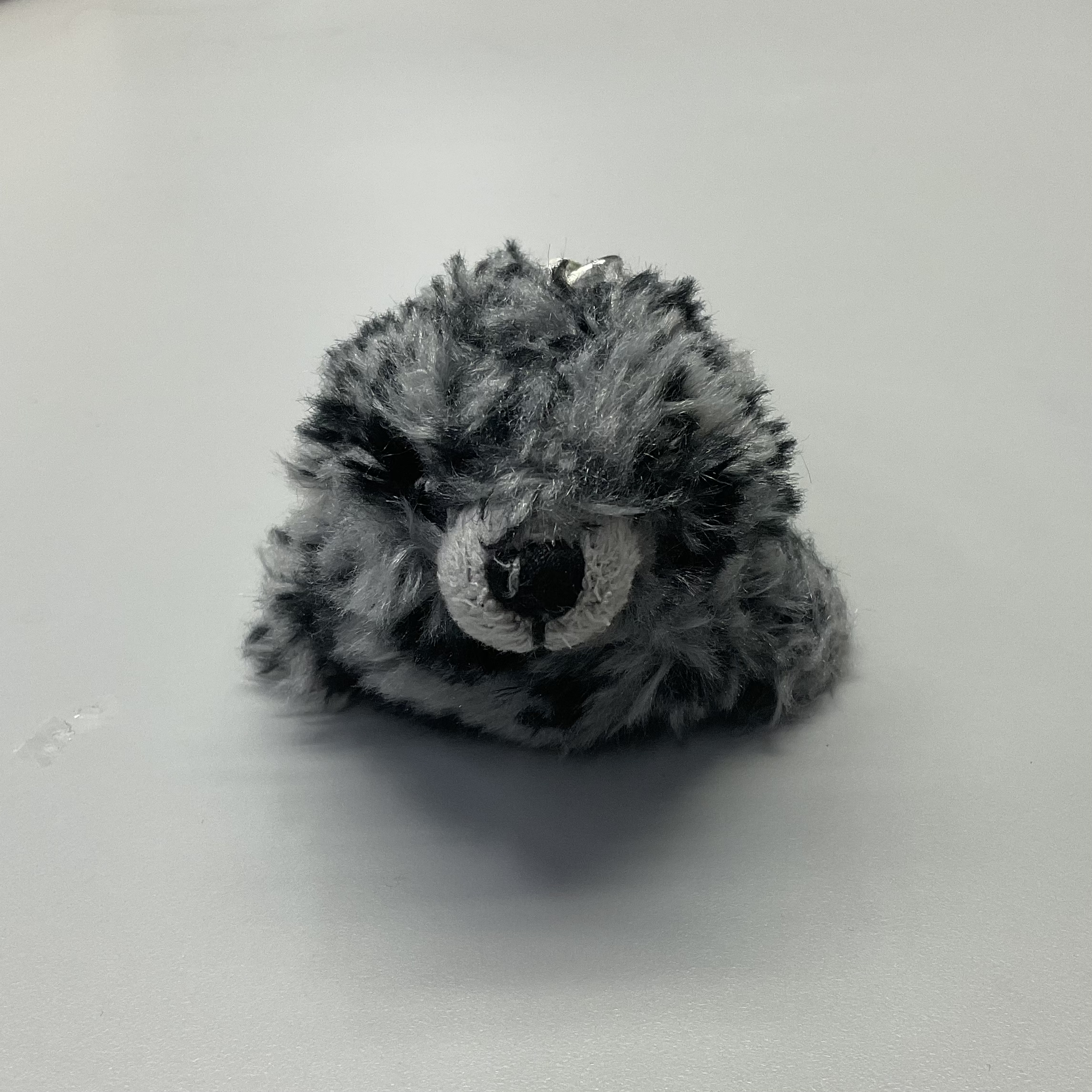 front view of a grey seaotter plush doll